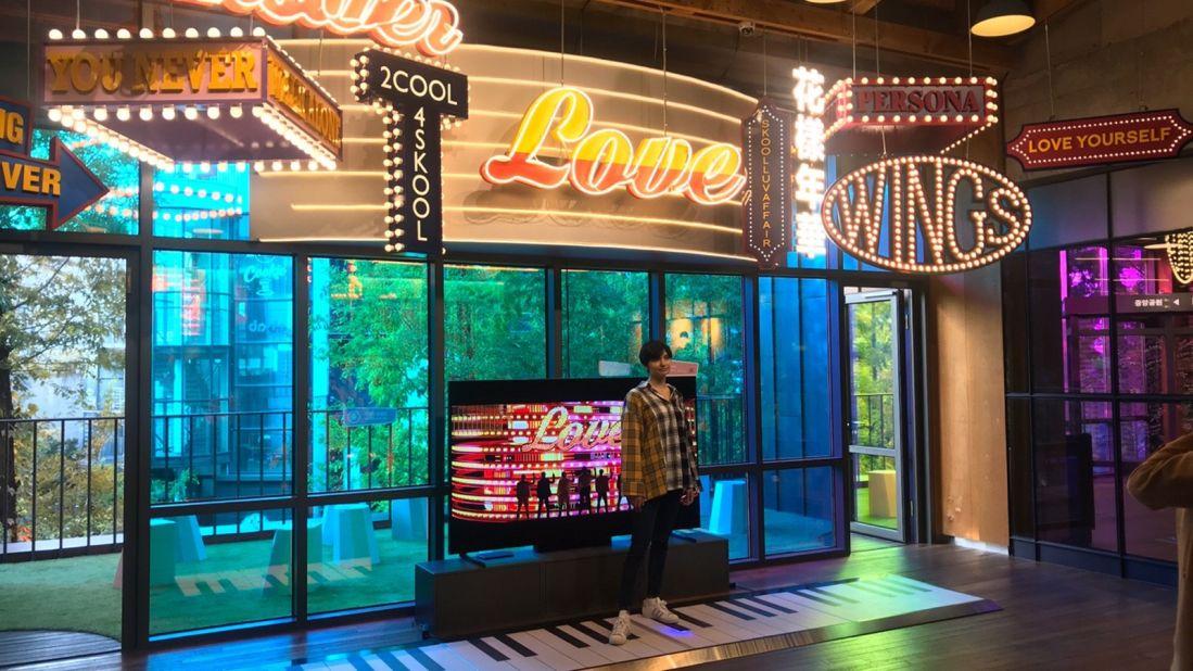 <strong>Photo ops: </strong>A fan takes pictures in front of a replica set with a floor piano that was used by the BTS member Suga in the 